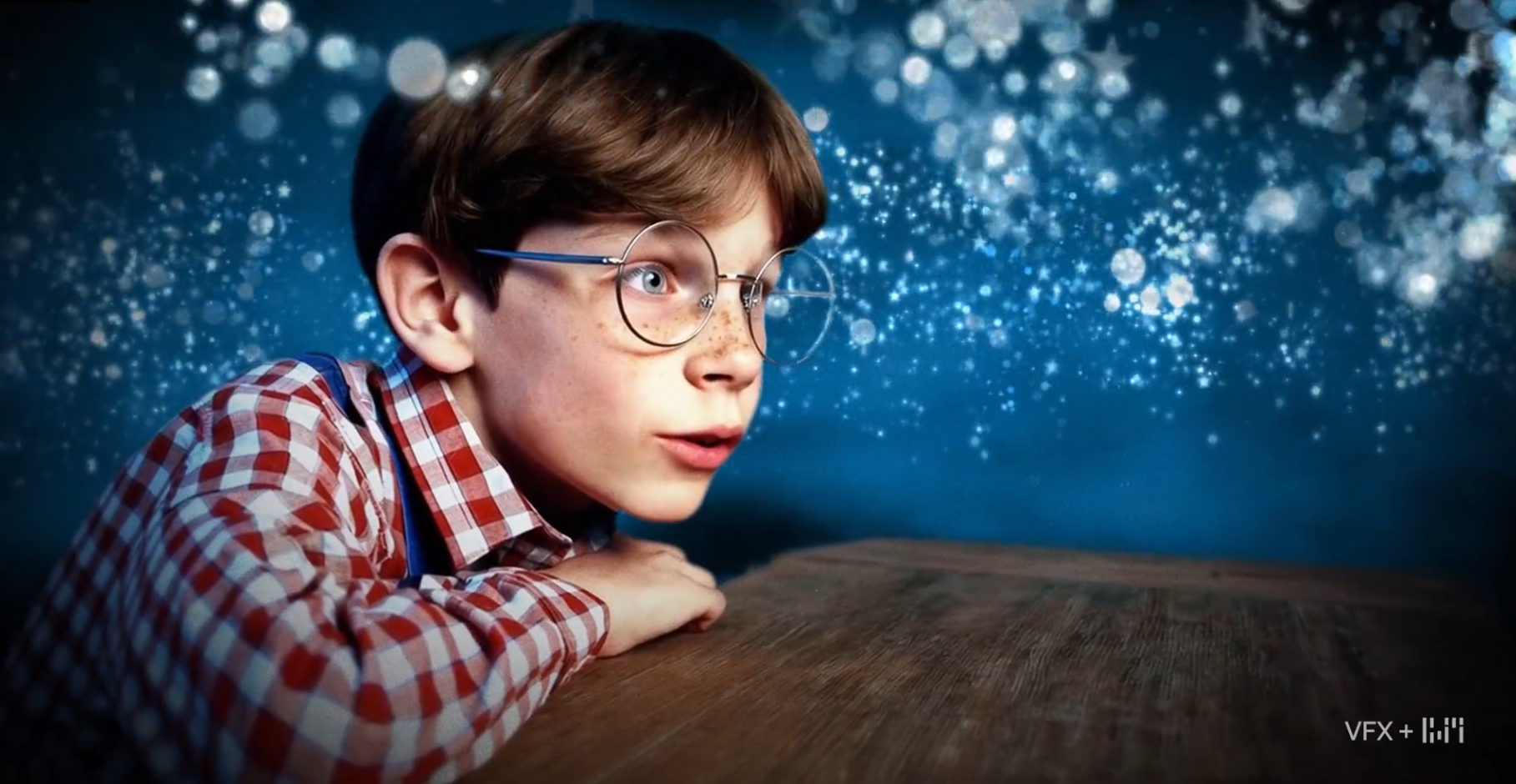a boy wearing glasses and looking at something